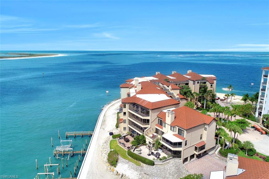 623 La Peninsula Boulevard, Unit 623 Naples, FL 34113 - Photo 2 of 27 an aerial view of a house with a ocean view
