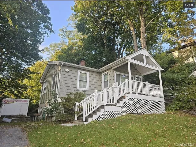 a view of a house with a yard and a porch