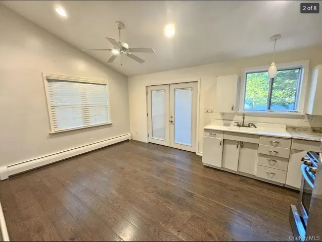 a view of a kitchen with a sink dishwasher and a large window