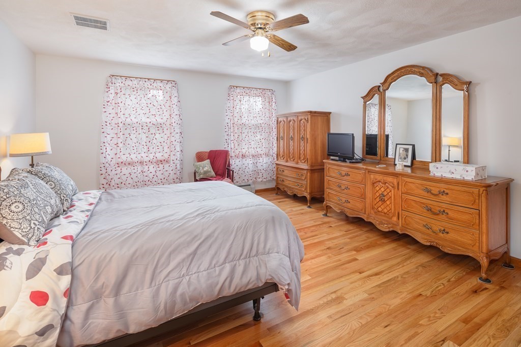 22 Stonehedge Circle Billerica, MA 01821 - Photo 11 of 30 a bedroom with a bed and a dresser