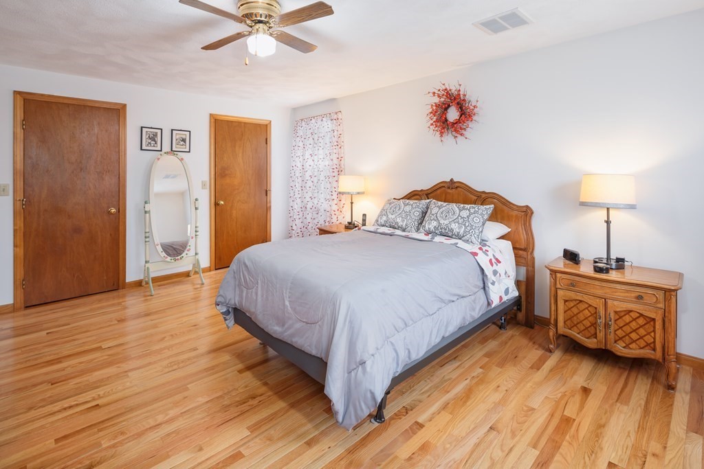22 Stonehedge Circle Billerica, MA 01821 - Photo 12 of 30 a spacious bedroom with a bed and a chandelier