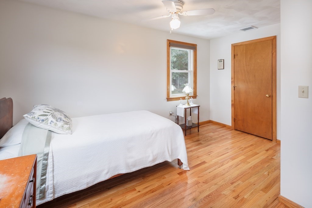 22 Stonehedge Circle Billerica, MA 01821 - Photo 14 of 30 a spacious bedroom with a bed and wooden floor