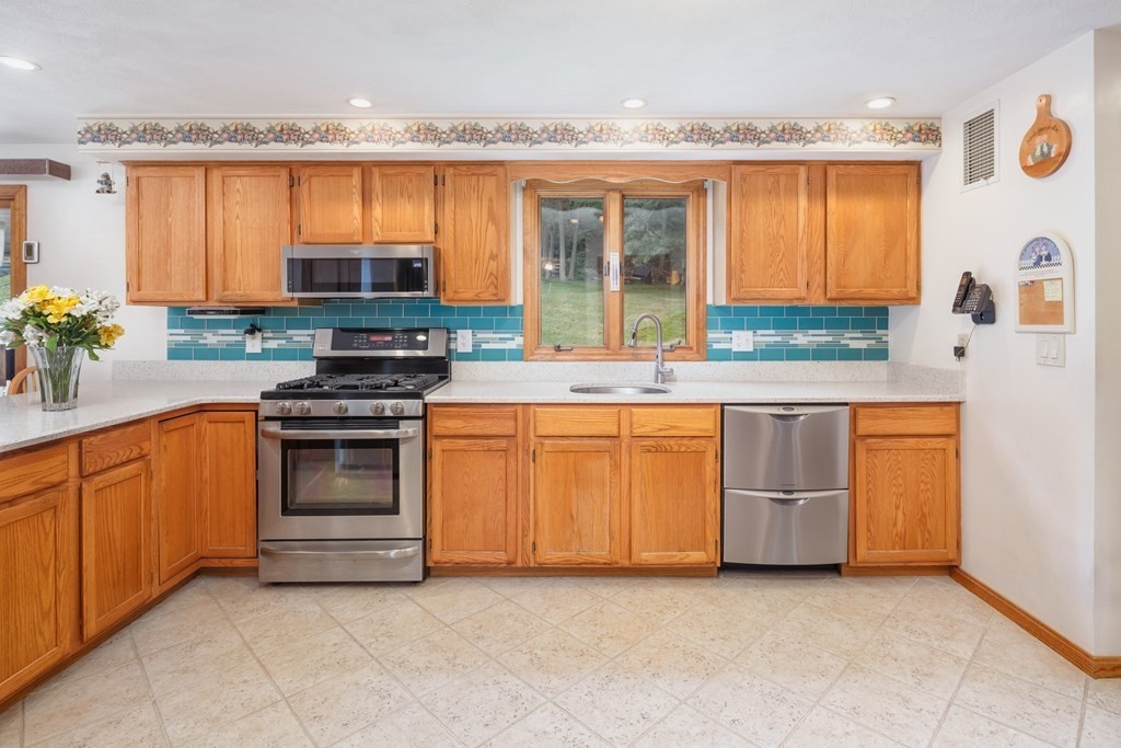 22 Stonehedge Circle Billerica, MA 01821 - Photo 4 of 30 a kitchen with stainless steel appliances a stove sink and microwave