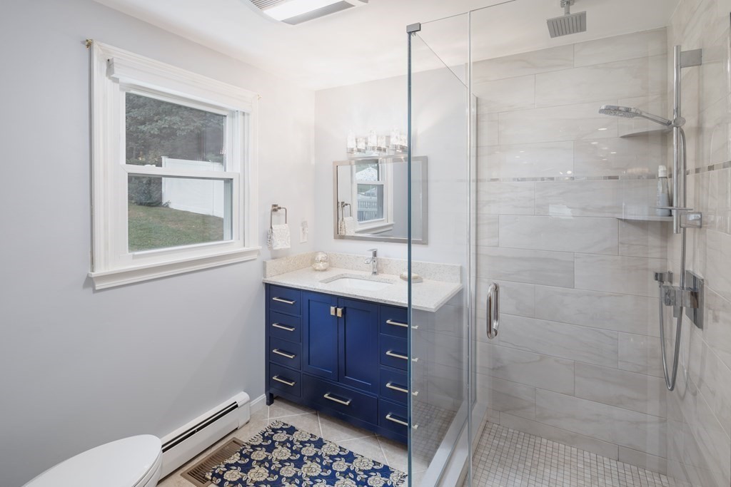 22 Stonehedge Circle Billerica, MA 01821 - Photo 5 of 30 a bathroom with a sink and a mirror