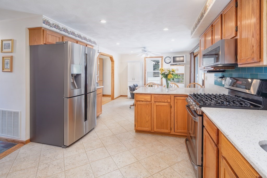 22 Stonehedge Circle Billerica, MA 01821 - Photo 6 of 30 a kitchen with refrigerator and cabinets