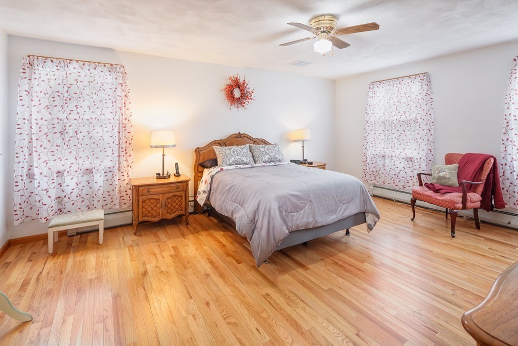 22 Stonehedge Circle Billerica, MA 01821 - Photo 10 of 30 a bedroom with a bed and a chandelier