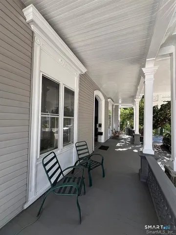 a balcony with furniture and a potted plant
