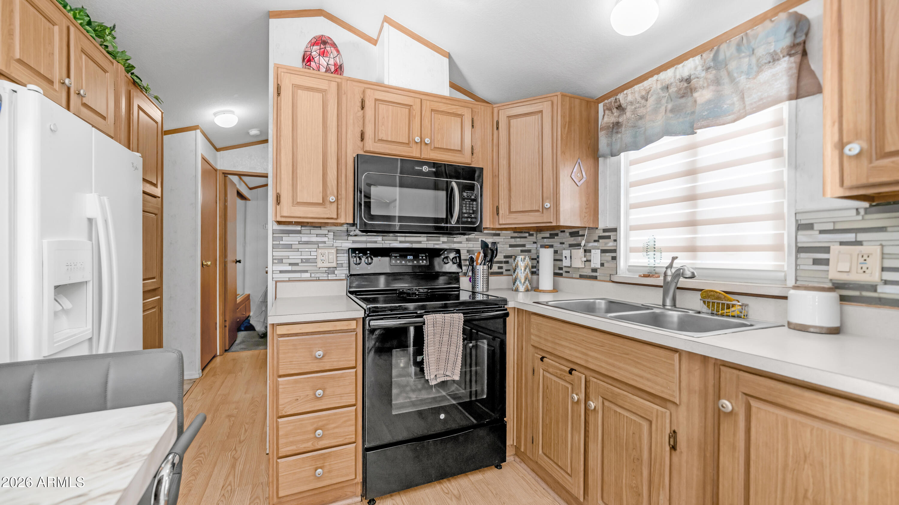 698 Felspar Drive, Unit 698 Apache Junction, AZ 85119 - Photo 12 of 62 a kitchen with stainless steel appliances a stove sink microwave and refrigerator