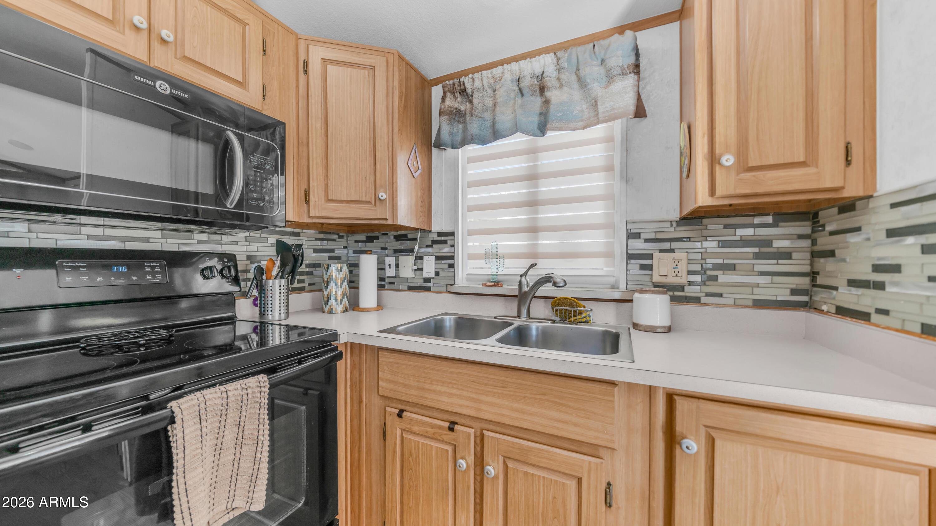 698 Felspar Drive, Unit 698 Apache Junction, AZ 85119 - Photo 13 of 62 a kitchen with stainless steel appliances a sink stove and cabinets