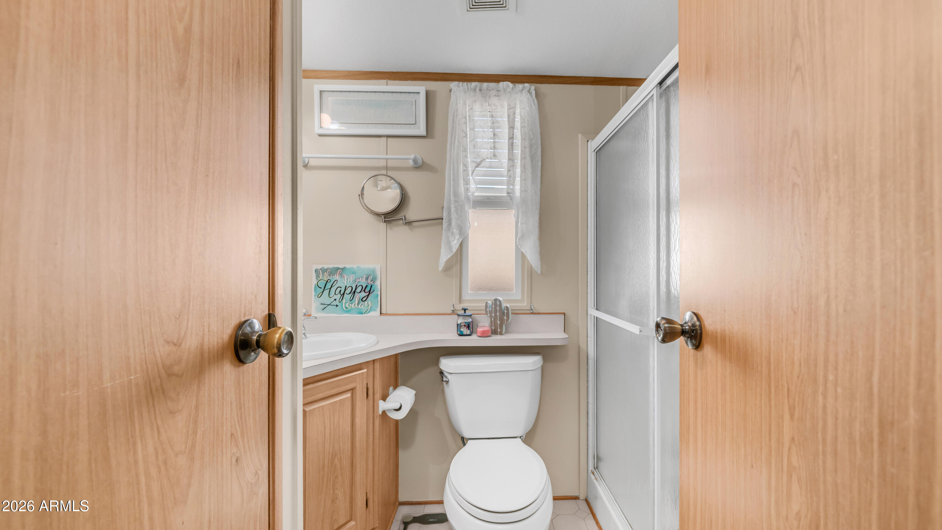 698 Felspar Drive, Unit 698 Apache Junction, AZ 85119 - Photo 18 of 62 a bathroom with a toilet sink and mirror