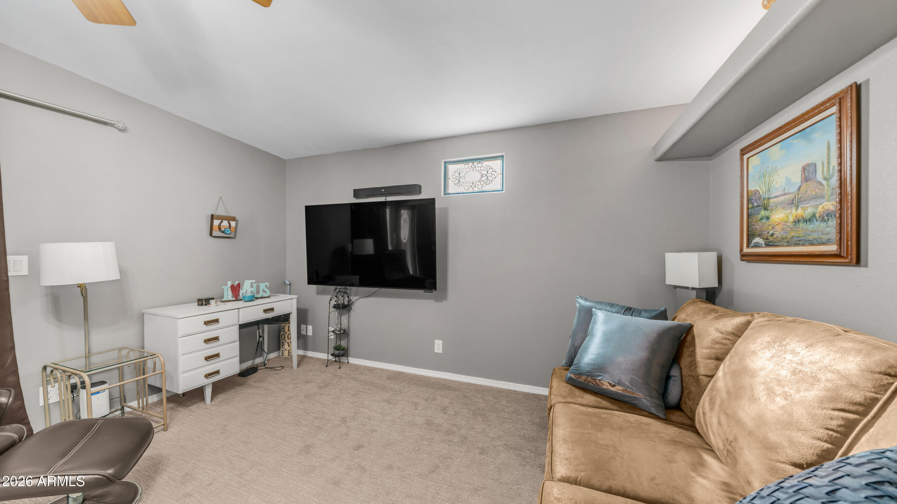 698 Felspar Drive, Unit 698 Apache Junction, AZ 85119 - Photo 21 of 62 a bedroom with furniture and a flat screen tv