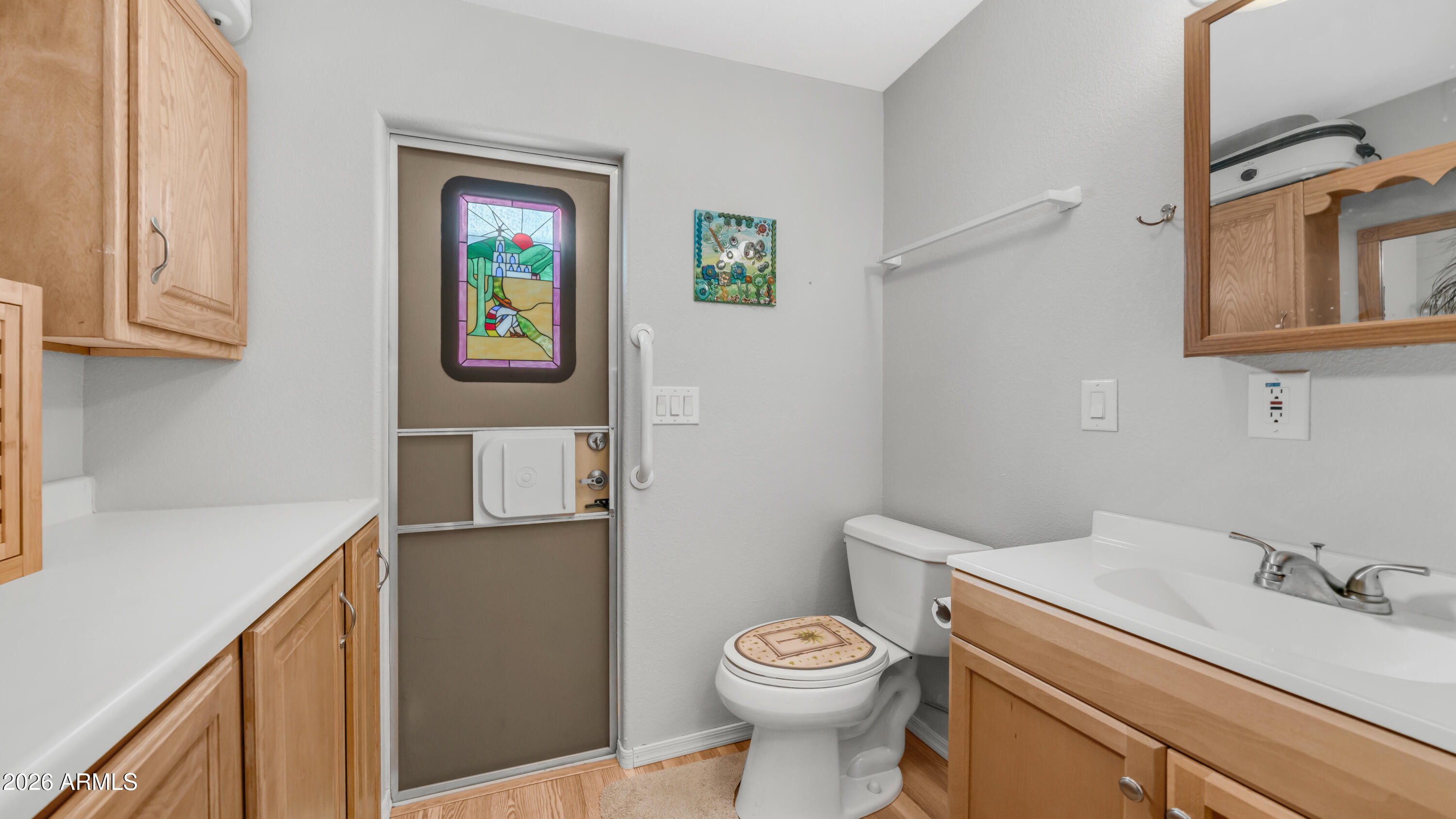 698 Felspar Drive, Unit 698 Apache Junction, AZ 85119 - Photo 24 of 62 a bathroom with a toilet a sink and mirror