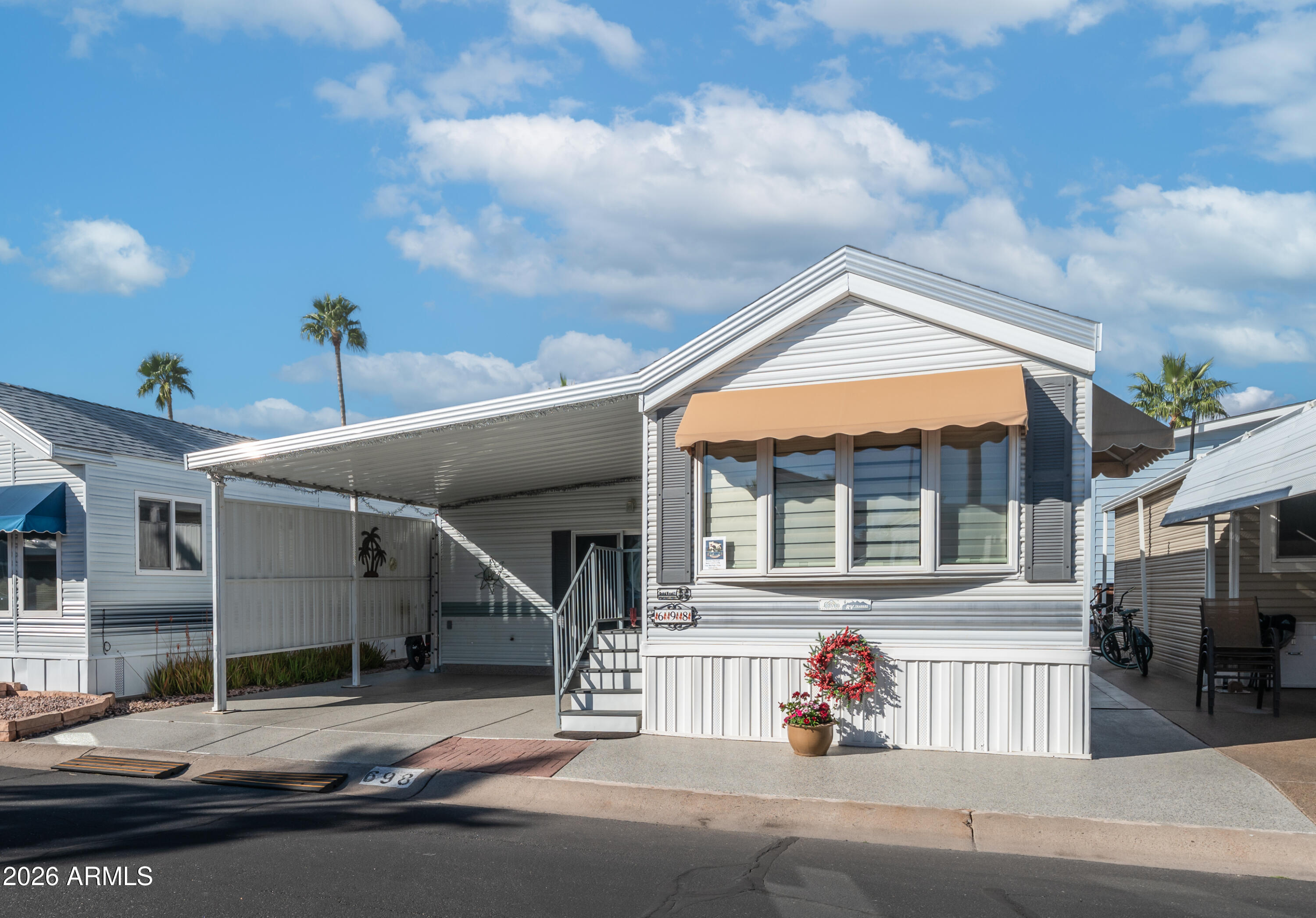 698 Felspar Drive, Unit 698 Apache Junction, AZ 85119 - Photo 4 of 62 a man walking down a street next to a building