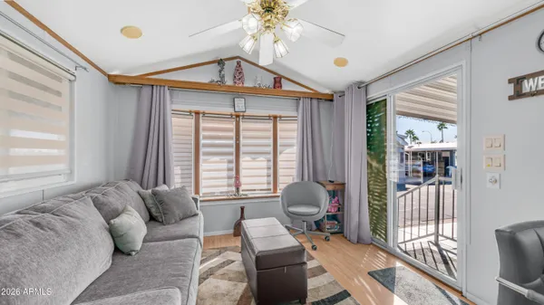 a living room with furniture and a kitchen