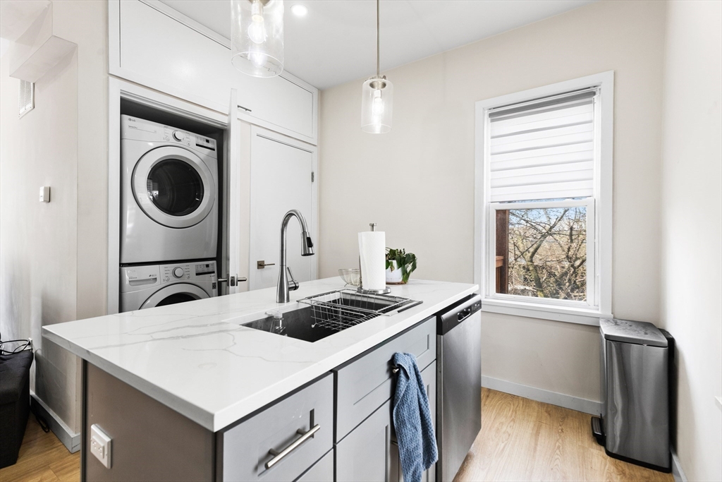 7 Transit Street, Unit 3 Boston, MA 02127 - Photo 2 of 10 a utility room with sink dryer and washer