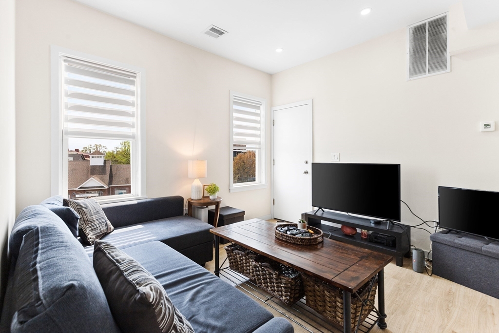 7 Transit Street, Unit 3 Boston, MA 02127 - Photo 6 of 10 a living room with furniture and a flat screen tv