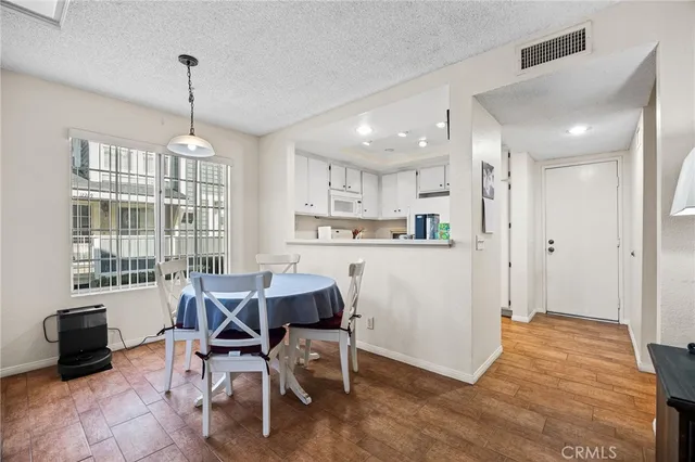 a living room with furniture a dining table and a large window