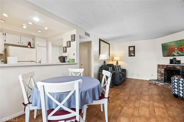 a dining room with furniture and a flat screen tv