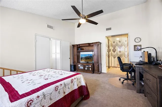 a bedroom that has a bed and a desk in it