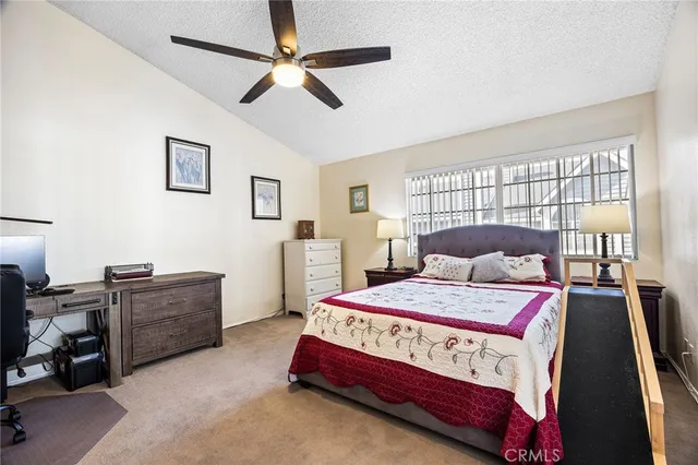 a bedroom with a bed dresser and a window