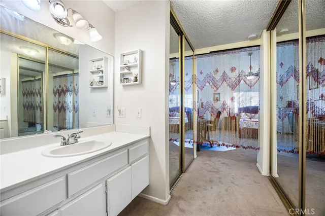 a en suite bathroom with a sink a mirror and a shower