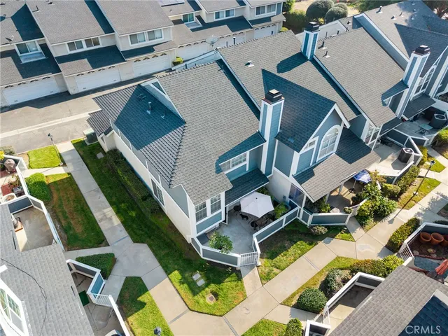 an aerial view of a house with swimming pool and ocean view
