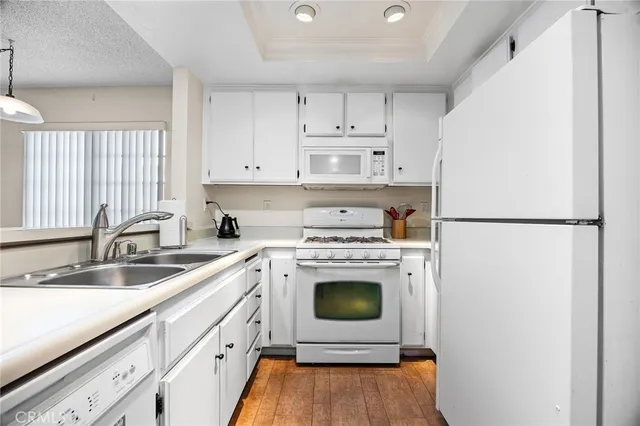 a kitchen with cabinets a refrigerator and a sink