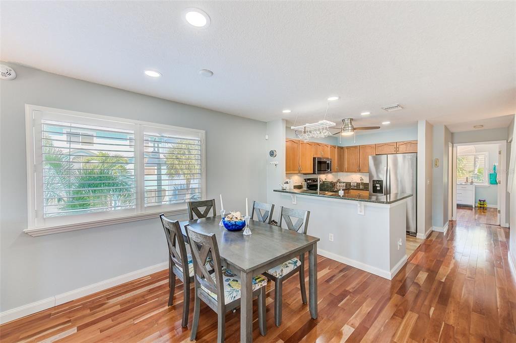 205 Marcdale Boulevard Indian Rocks Beach, FL 33785 - Photo 11 of 59 a kitchen with a table and chairs in it
