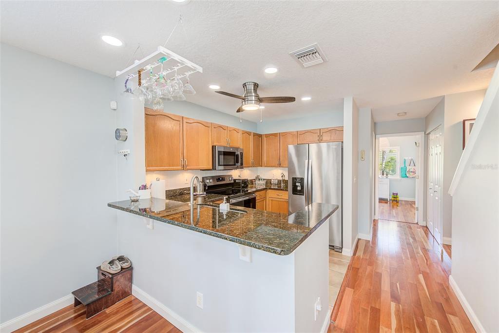 205 Marcdale Boulevard Indian Rocks Beach, FL 33785 - Photo 9 of 59 a kitchen with stainless steel appliances granite countertop a sink a stove and a refrigerator