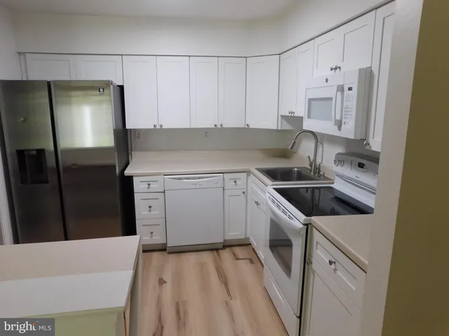 a kitchen with a sink stove and refrigerator