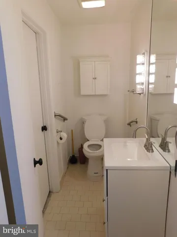 a bathroom with a sink a toilet and a mirror