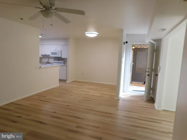a view of a kitchen with a sink and a refrigerator