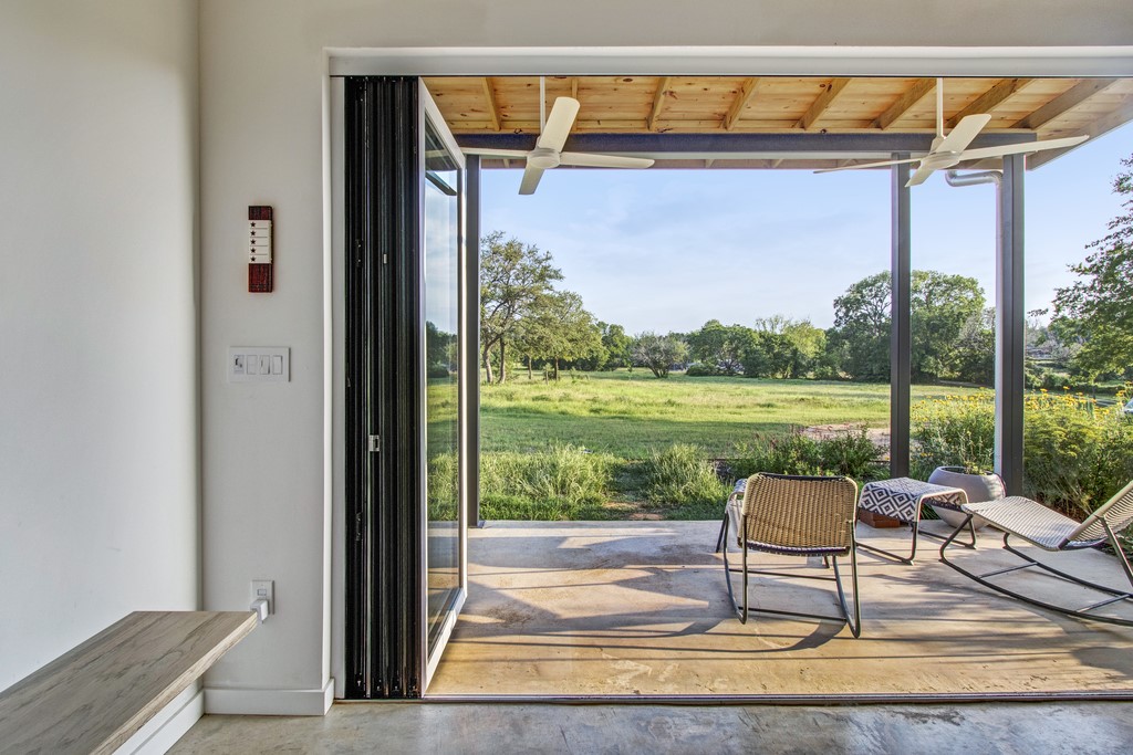 534 Old McDade Road Elgin, TX 78621 - Photo 8 of 40 Glass front doors fully open into a 12-foot wide entryway, facing the prevailing wind.