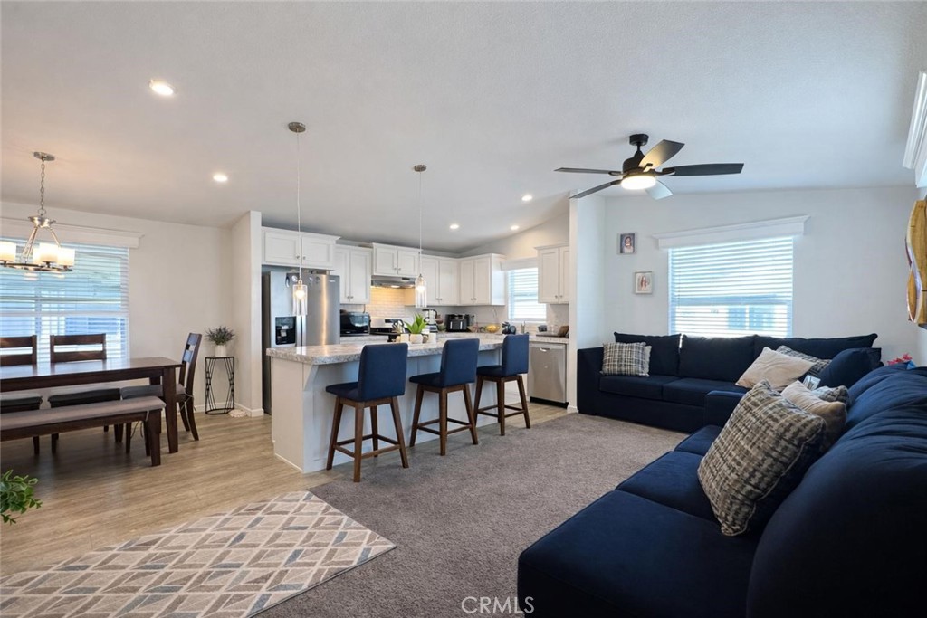 16600 Orange Avenue, Unit 130 Paramount, CA 90723 - Photo 11 of 31 a living room with furniture a dining table and a piano