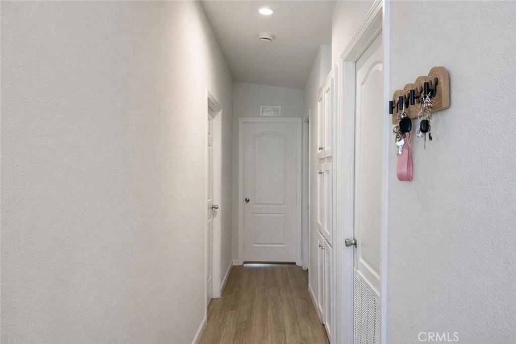 16600 Orange Avenue, Unit 130 Paramount, CA 90723 - Photo 12 of 31 a view of a hallway with wooden floor and a bathroom