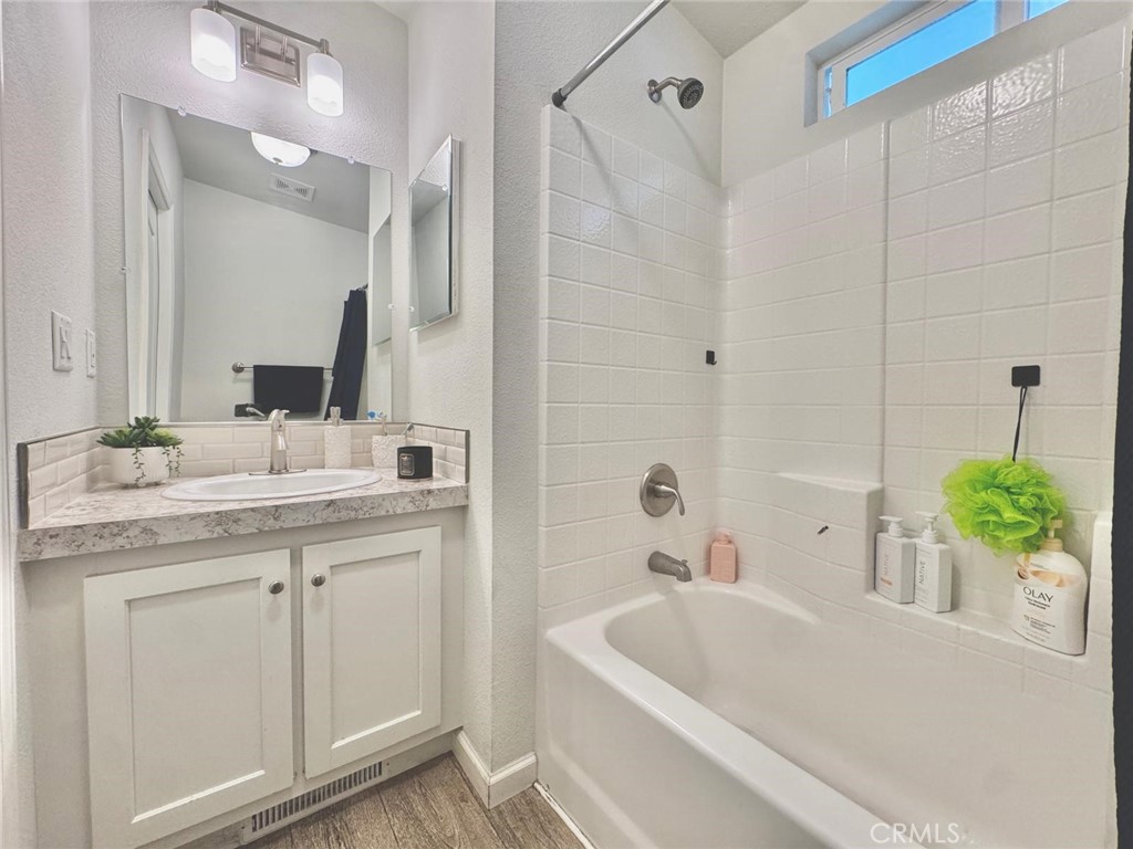 16600 Orange Avenue, Unit 130 Paramount, CA 90723 - Photo 17 of 31 a bathroom with a granite countertop sink and a bathtub