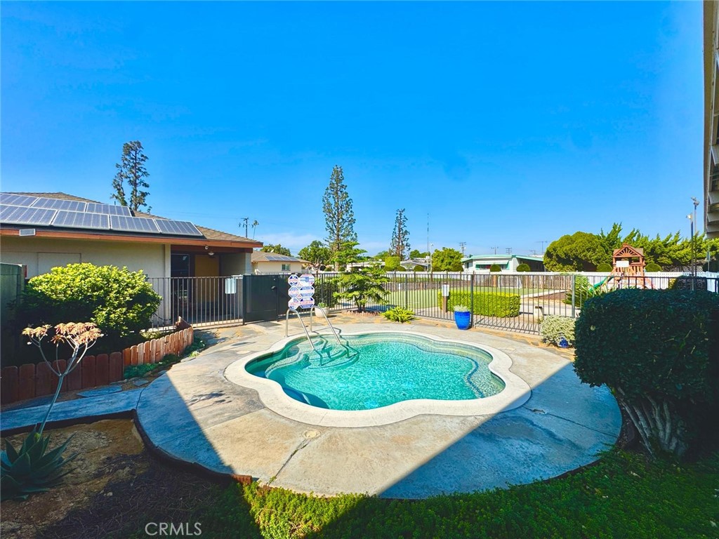 16600 Orange Avenue, Unit 130 Paramount, CA 90723 - Photo 24 of 31 a view of a swimming pool with a patio