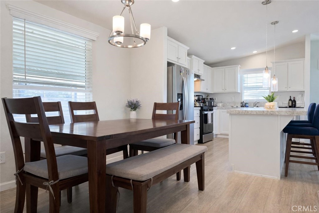 16600 Orange Avenue, Unit 130 Paramount, CA 90723 - Photo 8 of 31 a view of a dining room with furniture and wooden floor
