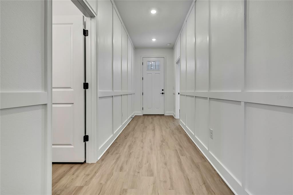 6589 Freeport Drive Spring Hill, FL 34608 - Photo 8 of 63 a view of a hallway with wooden floor