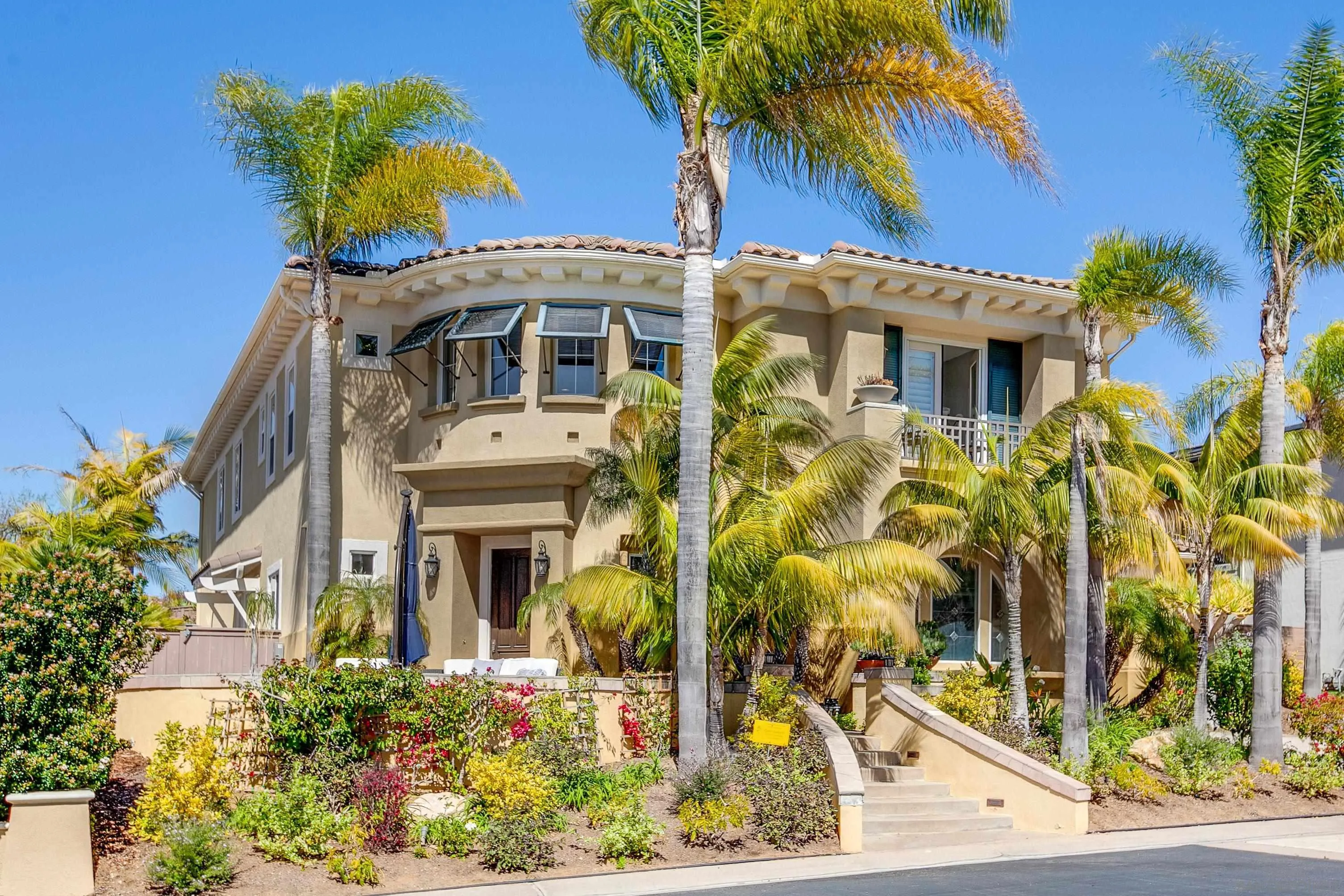 a front view of a multi story residential apartment building with yard