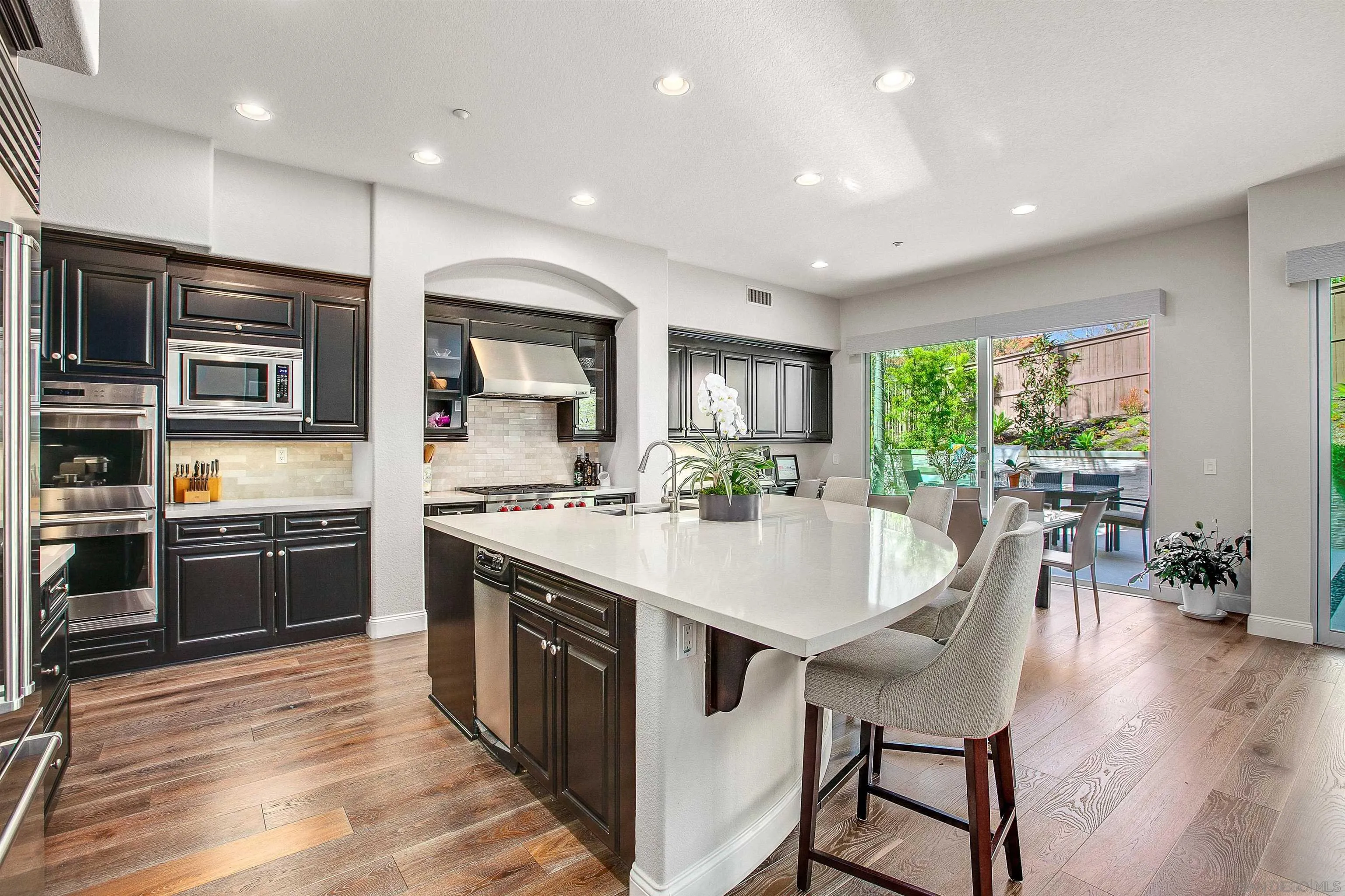 1460 Ravean Court Encinitas, CA 92024 - Photo 13 of 48 a large kitchen with kitchen island a large island in the center