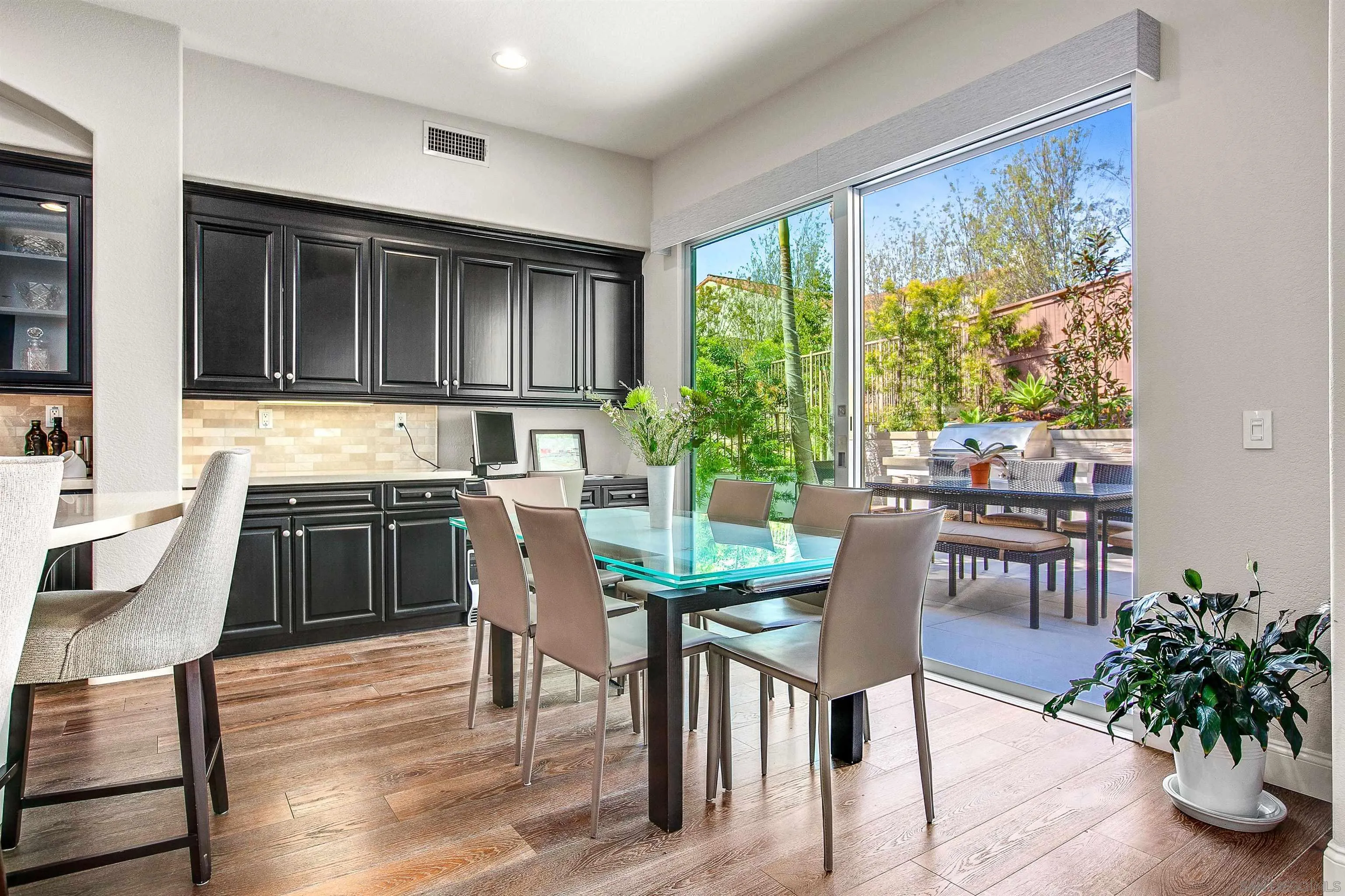 1460 Ravean Court Encinitas, CA 92024 - Photo 14 of 48 a kitchen with a table chairs stove and cabinets