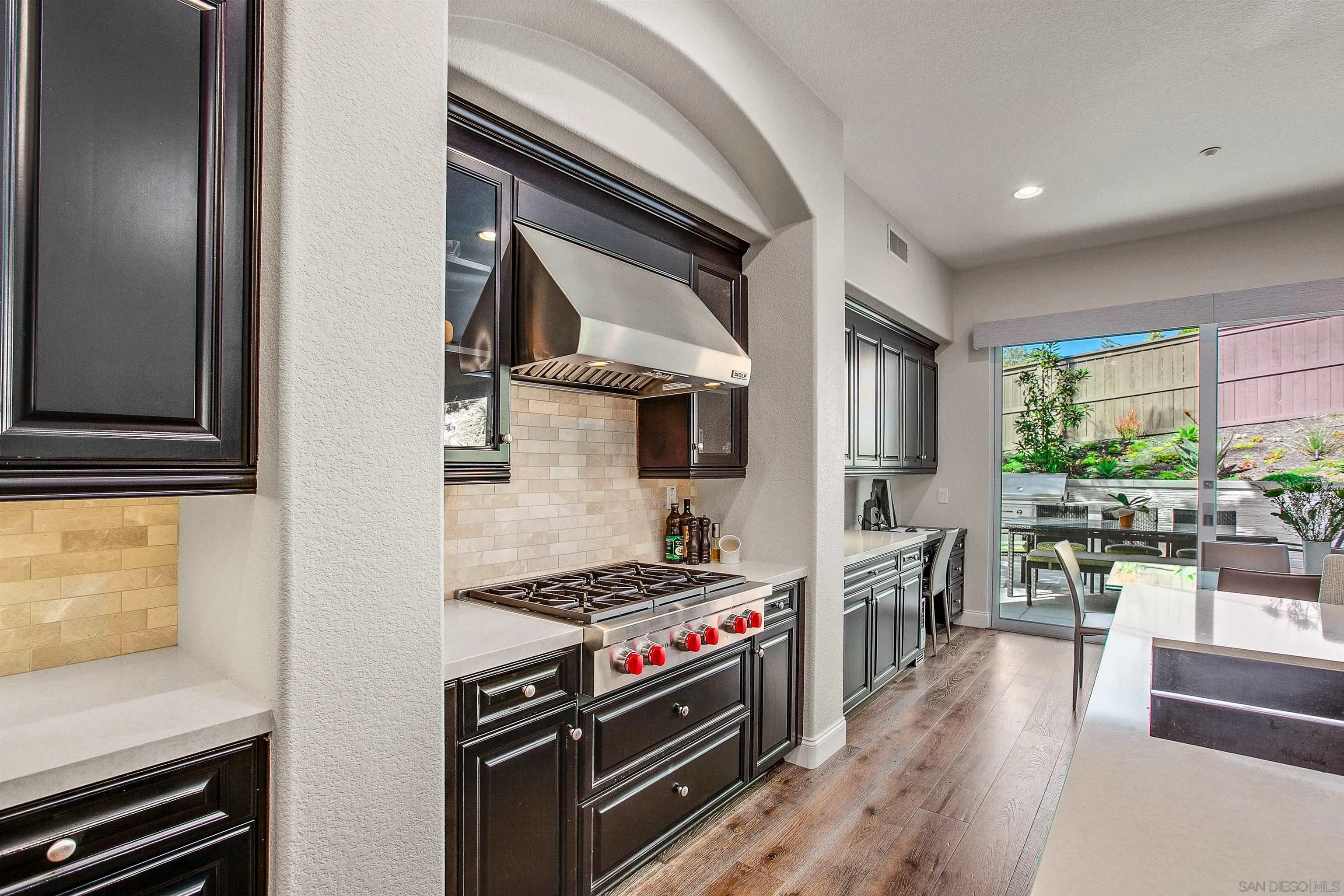 1460 Ravean Court Encinitas, CA 92024 - Photo 15 of 48 a kitchen with stainless steel appliances granite countertop a stove and a refrigerator