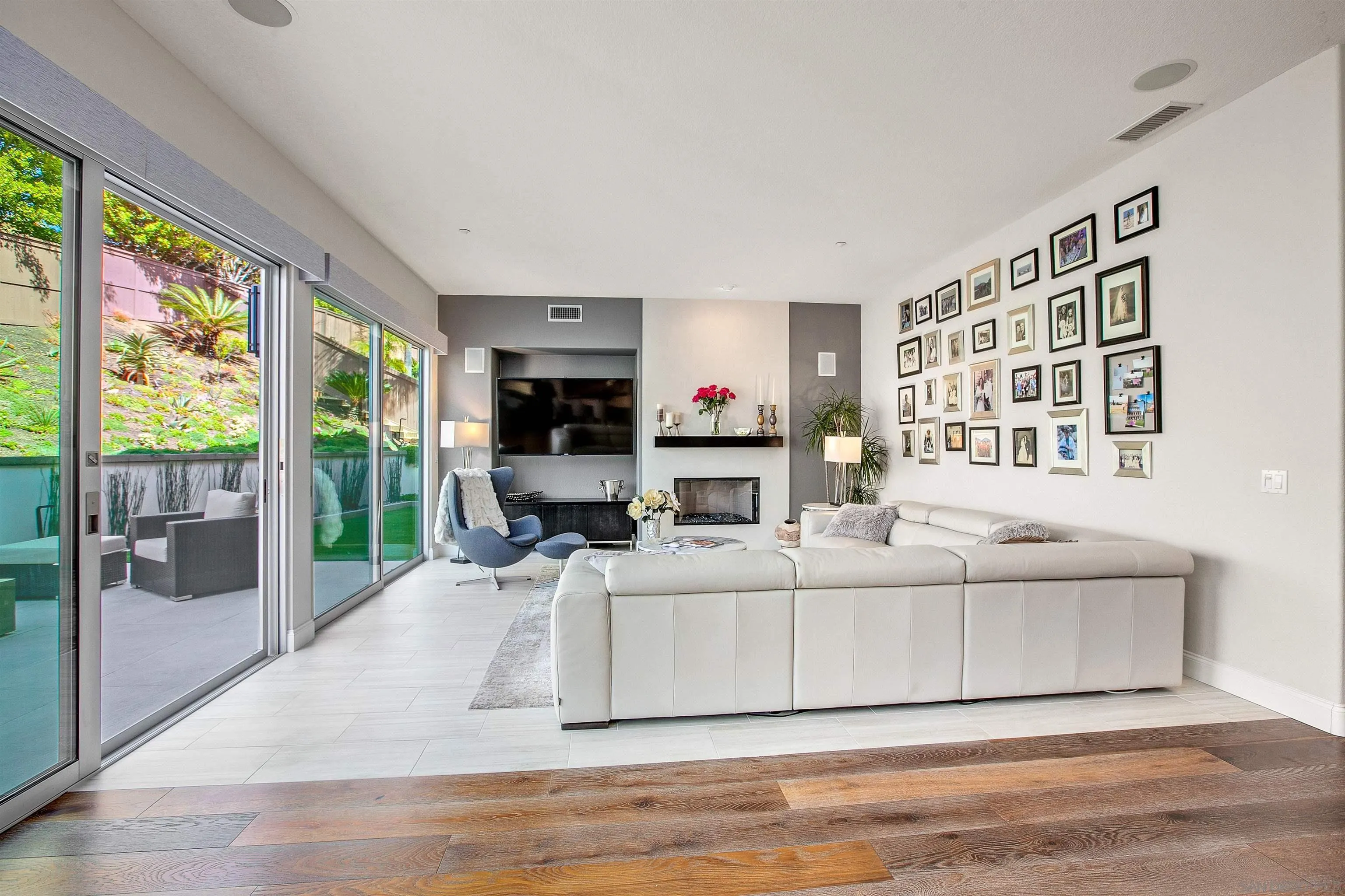 1460 Ravean Court Encinitas, CA 92024 - Photo 18 of 48 a living room with furniture a flat screen tv and a large window