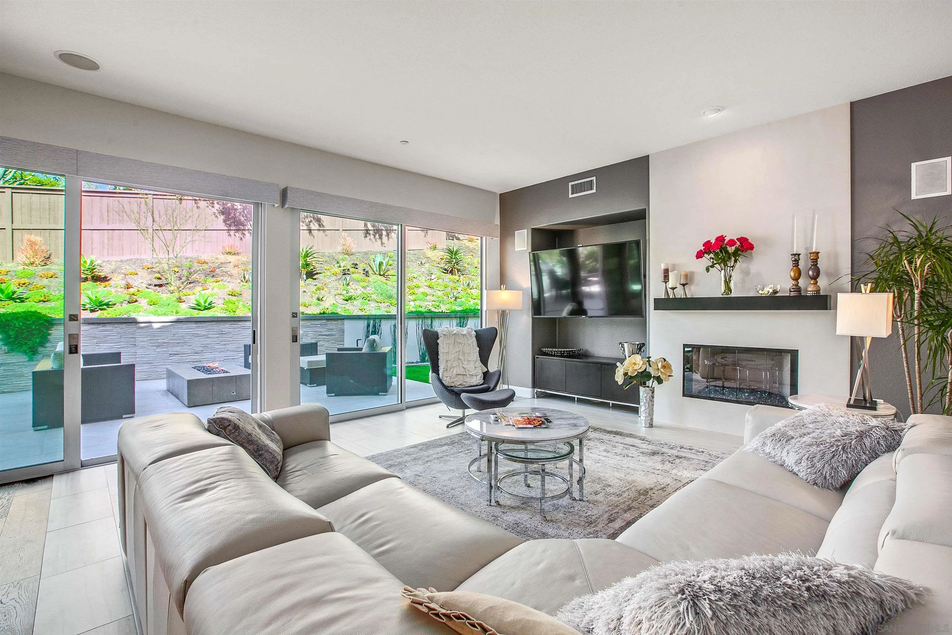 1460 Ravean Court Encinitas, CA 92024 - Photo 19 of 48 a living room with furniture potted plant and a fireplace