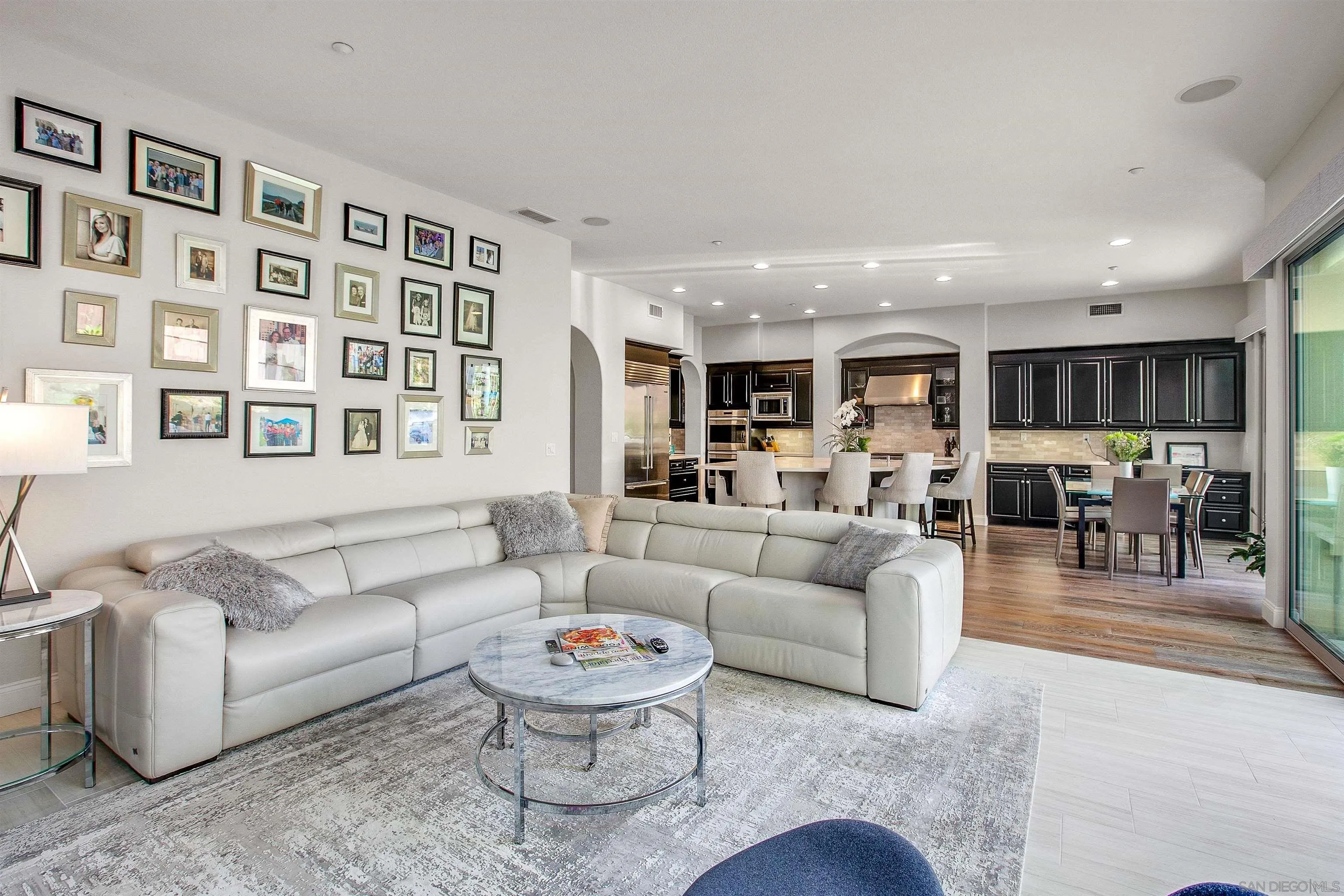 1460 Ravean Court Encinitas, CA 92024 - Photo 20 of 48 a living room with furniture kitchen view and a wooden floor