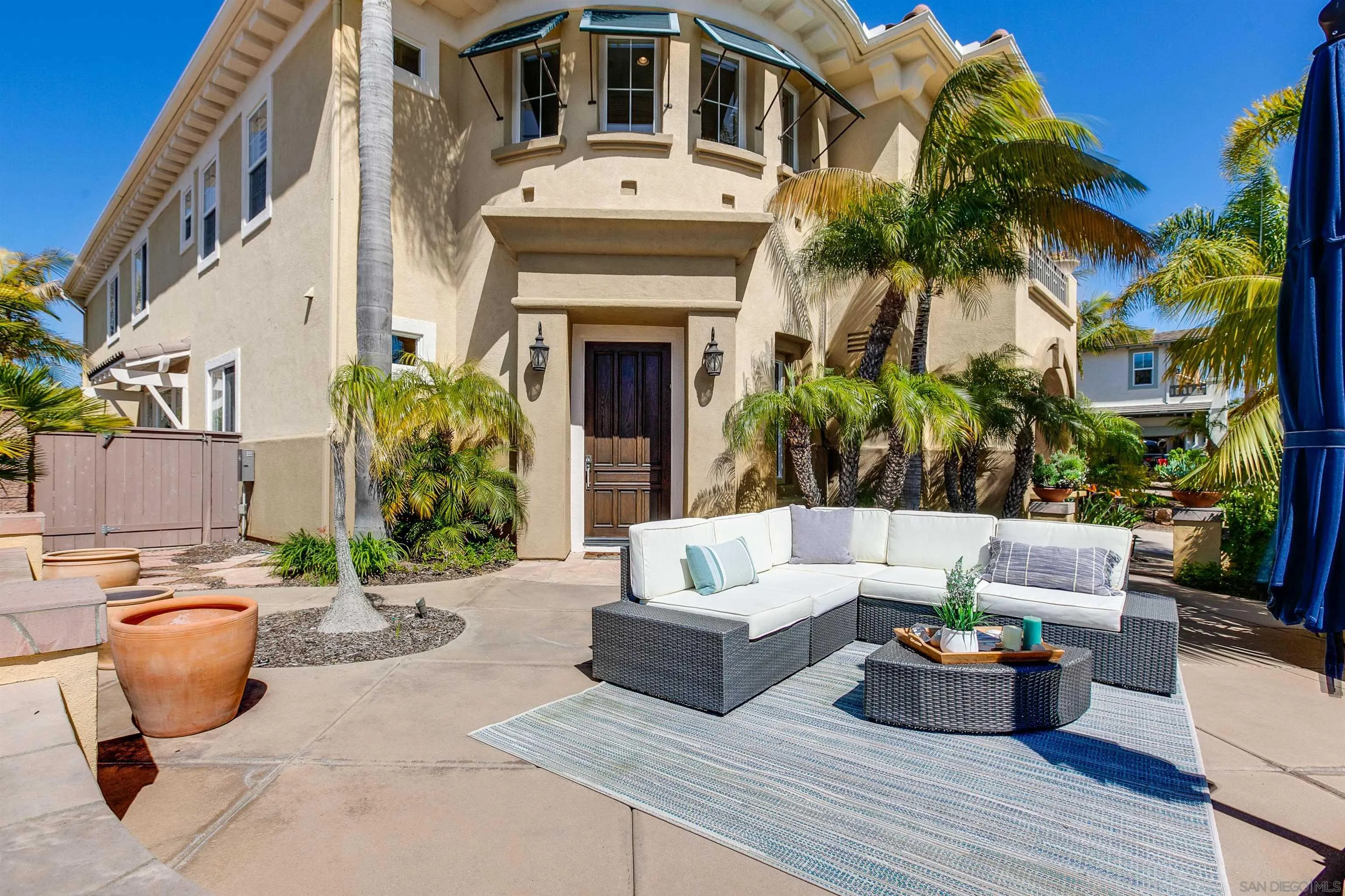 1460 Ravean Court Encinitas, CA 92024 - Photo 2 of 48 a view of a patio with couches and a potted plant on a table