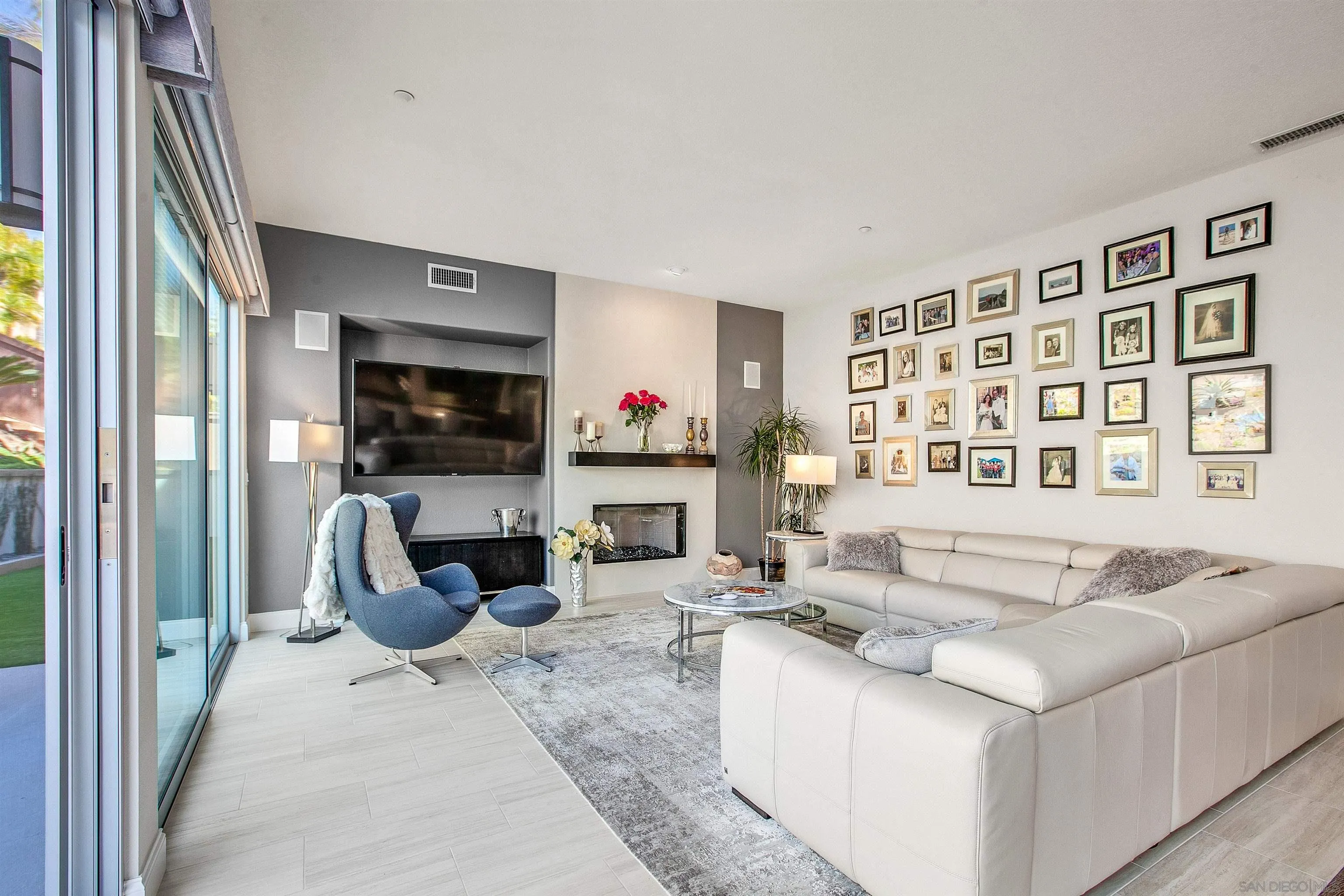 1460 Ravean Court Encinitas, CA 92024 - Photo 21 of 48 a living room with furniture a flat screen tv and a fireplace