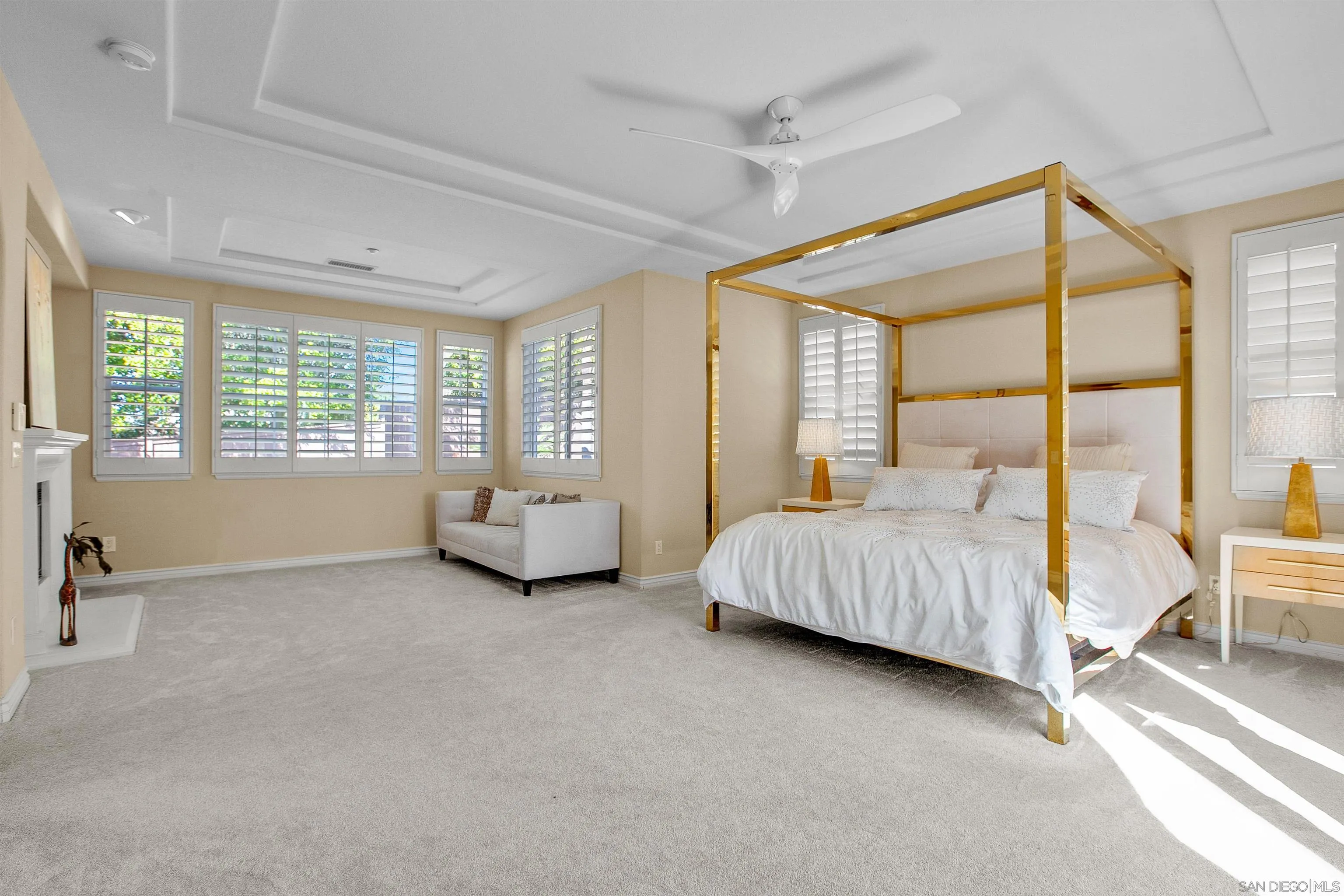 1460 Ravean Court Encinitas, CA 92024 - Photo 25 of 48 a spacious bedroom with a bed and a couch