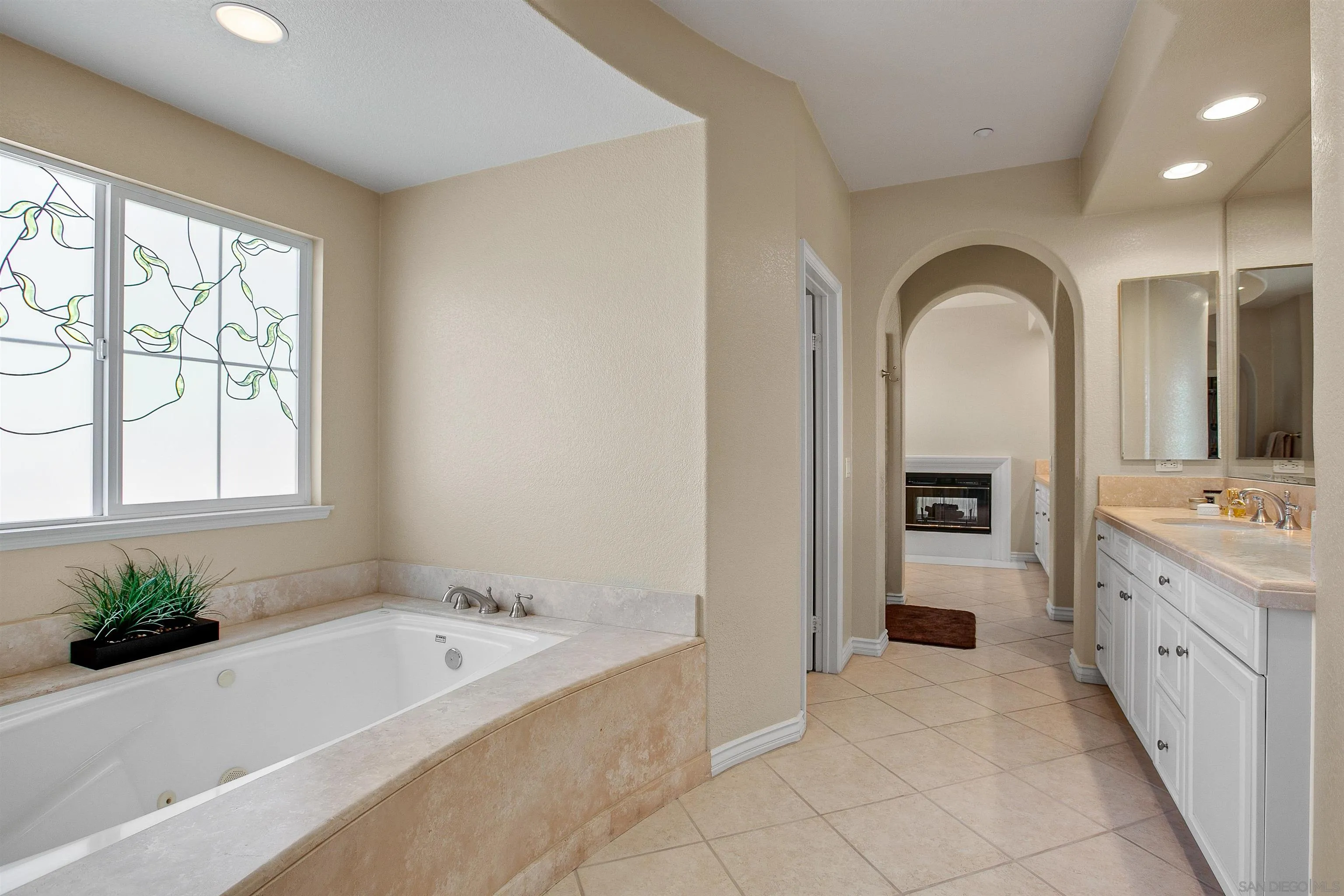 1460 Ravean Court Encinitas, CA 92024 - Photo 32 of 48 a spacious bathroom with a tub sink and mirror